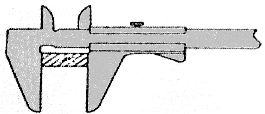 Vernier caliper performing an external measurement on a small, rectangular workpiece.